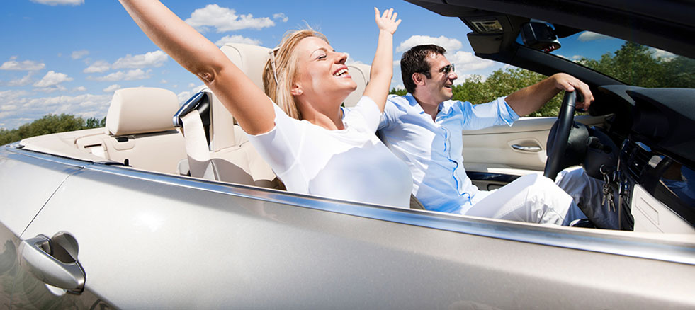 people enjoying a ride in a convertible car